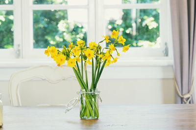 Close-up of yellow tulip in vase on table at home