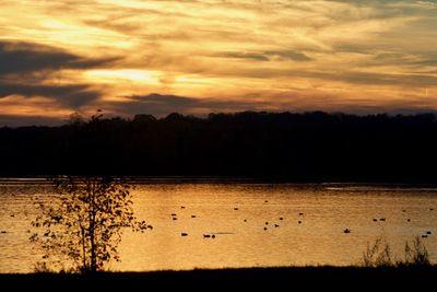 Scenic view of lake against orange sky
