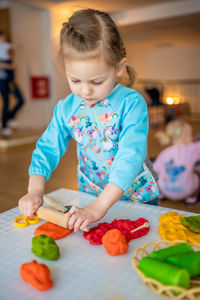 Portrait of cute boy playing with toy blocks at home