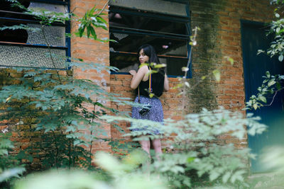 Woman standing against wall