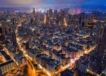 Aerial view of illuminated cityscape against sky at night