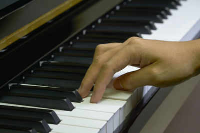 Close-up of man playing piano