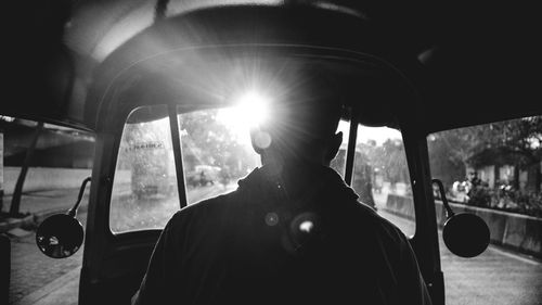 Man driving through car window