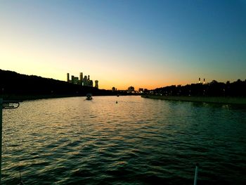 Scenic view of river against clear sky during sunset