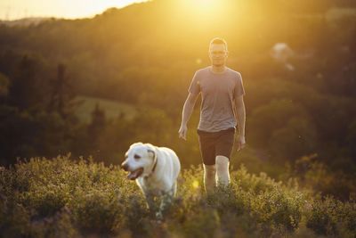 Portrait of man walking on field
