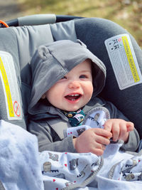 Portrait of cute baby boy smiling outside