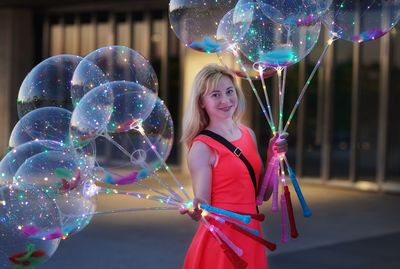 Portrait of a smiling young woman at night