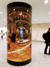 People in illuminated building at night