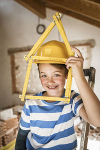 Portrait of smiling boy holding camera