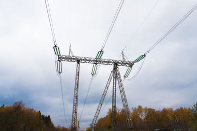 Low angle view of electricity pylon against sky