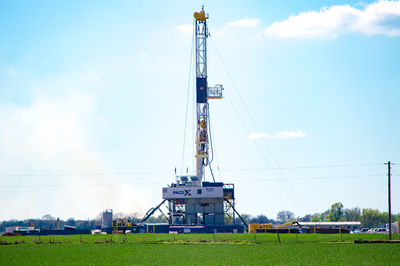 Crane on field against sky