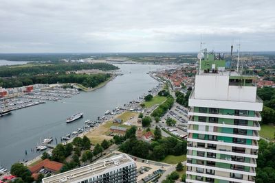 High angle view of buildings and sea against sky