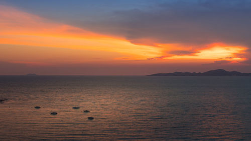 Scenic view of sea against orange sky