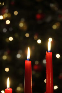 Close-up of lit candles against blurred background