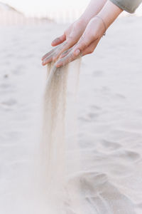 Midsection of person hand on water