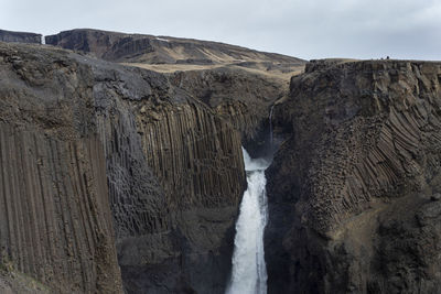 Landscape of the waterfall litlanesfoss among the basalt rocks