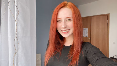 Portrait of smiling woman at home