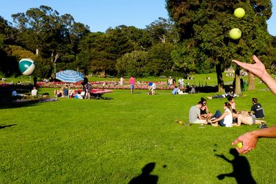 People on grassy field in park
