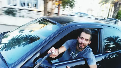 Portrait of young man in car