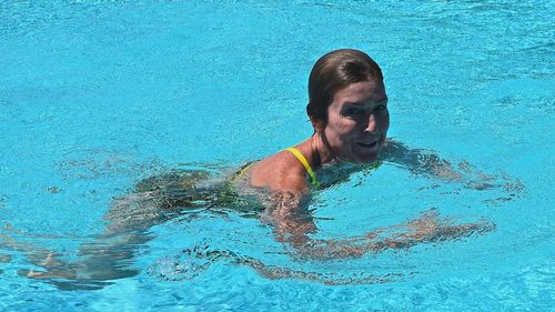 Portrait of woman swimming in pool