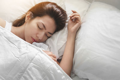 High angle view of baby sleeping on bed