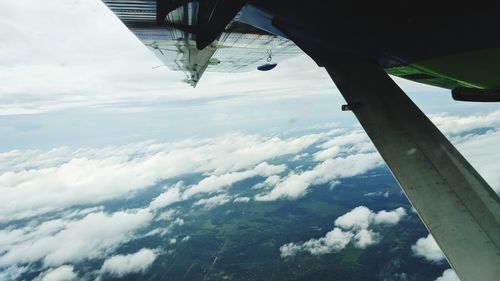 Low angle view of airplane wing against sky