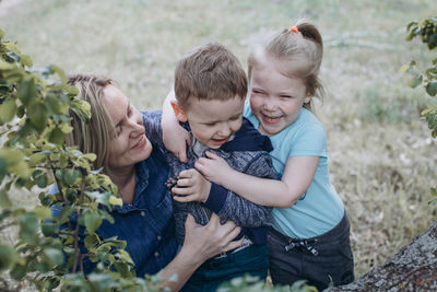 Hugs and laughter of mom and two children