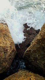 Close-up of wave on beach against sky