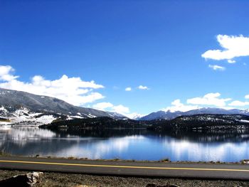 Scenic view of mountains against blue sky during winter