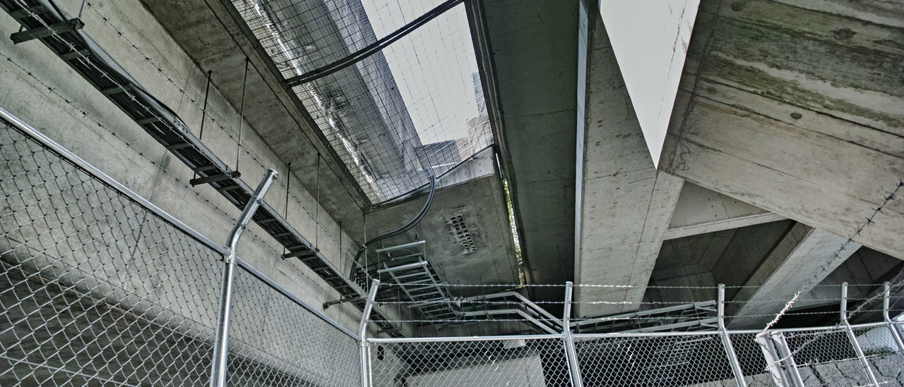 LOW ANGLE VIEW OF STAIRCASE IN ABANDONED BUILDING