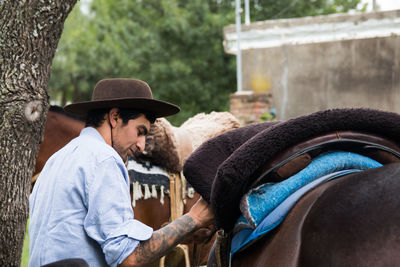 Man preparing horse to ride