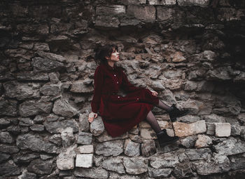 Full length of woman wearing red wall