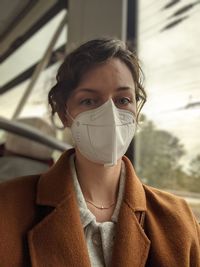 Portrait of woman wearing mask in bus