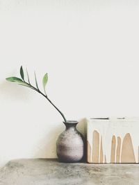 Close-up of vase on table against white background