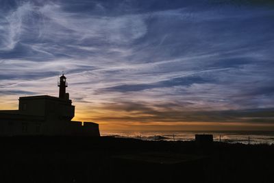 Silhouette building against sky during sunset
