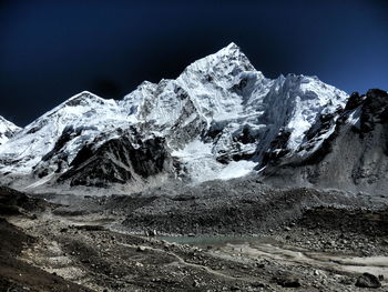 Scenic view of snowcapped mountains against clear sky