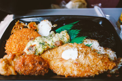 Close-up of fried chicken served on plate indoors