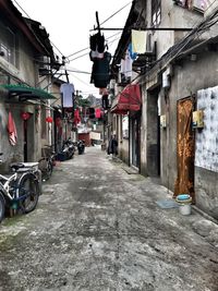 Street amidst hanging buildings in city