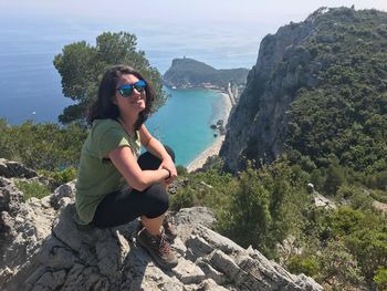 Young woman sitting on rock