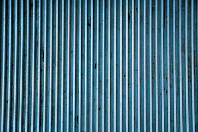 Striped blue metal plate texture close up