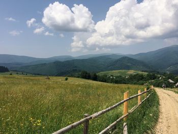 Scenic view of landscape against cloudy sky