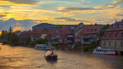 Boats in river with buildings in background