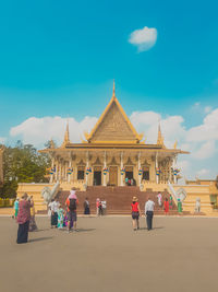 Group of people in front of building against sky