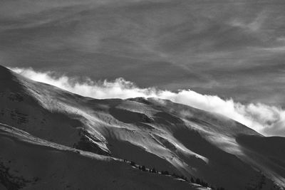 Scenic view of mountain against cloudy sky