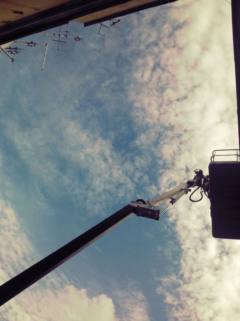 low angle view, sky, cloud - sky, cloudy, cloud, cable, power line, street light, electricity, lighting equipment, built structure, silhouette, no people, pole, day, outdoors, connection, overcast, weather, architecture