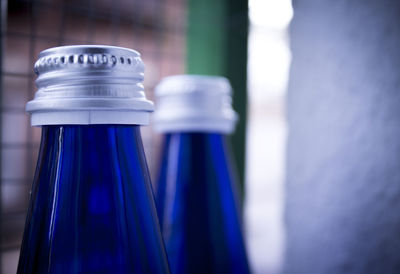 Close-up of blue glass bottles at home