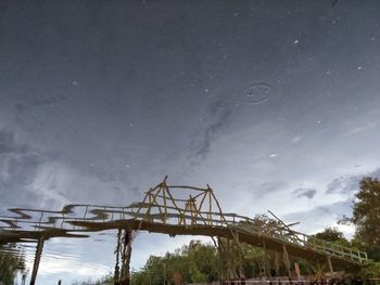 Electricity pylon against sky at night