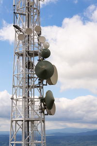 Low angle view of communications tower against sky