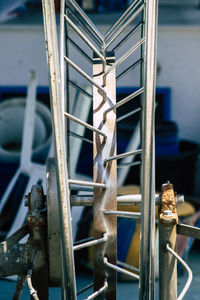 Close-up of old machinery on railing