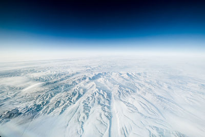 Aerial view of landscape against blue sky